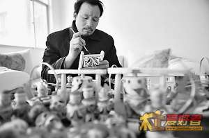 王学军对木旋玩具进行彩绘。